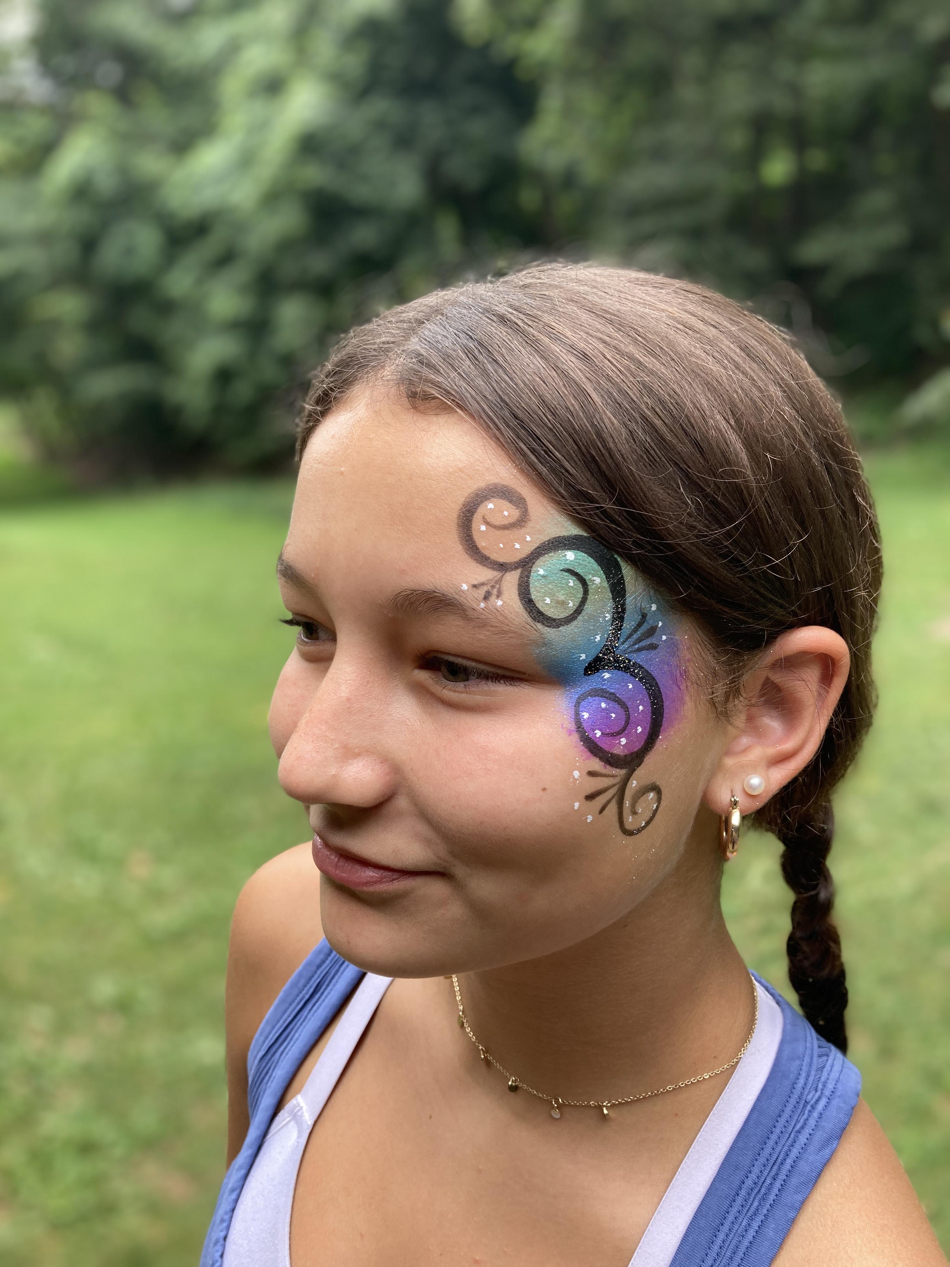 Girl with green / purple design next to her eye